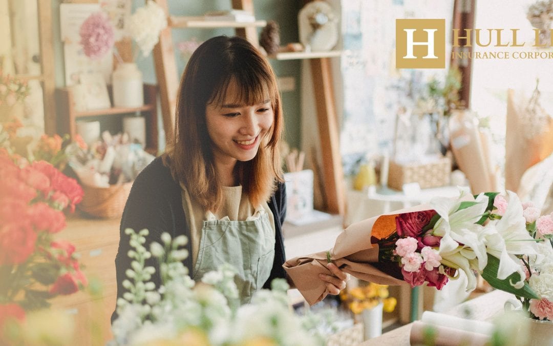 Small Business Owner With Life Insurance working in a florist surrounded by flowers