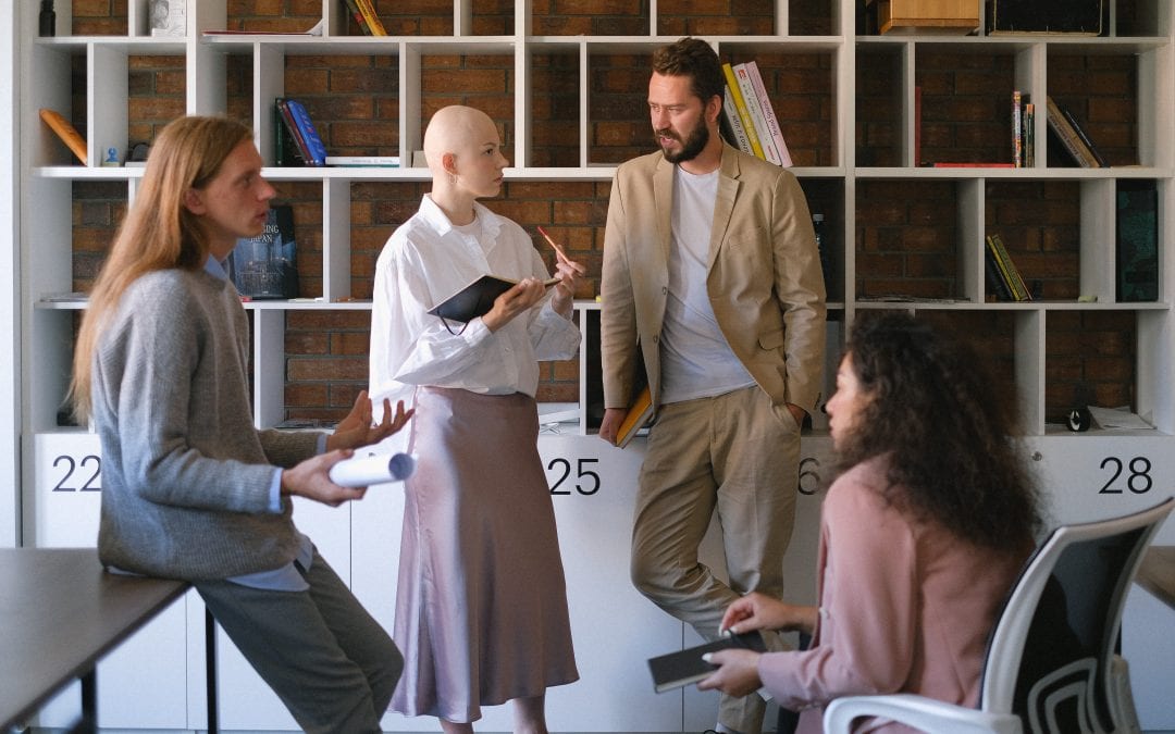 Serious coworkers communicating about disability insurance options in a business meeting