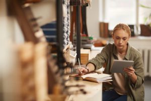 Young Woman Doing Calculations For Life Insurance