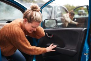 Female Motorist In Crash with Critical Illness Insurance Getting Out Of Car